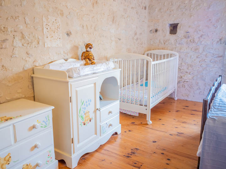 Fixed wooden cot and changing station, family friendly cottage in Charente, South west France